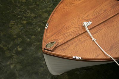 Cropped image of boat moored in lake