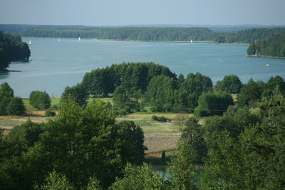 High angle view of lake amidst field against sky