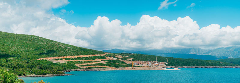 Panoramic view of sea and mountains against sky