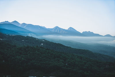 Scenic view of mountains against clear sky during sunset