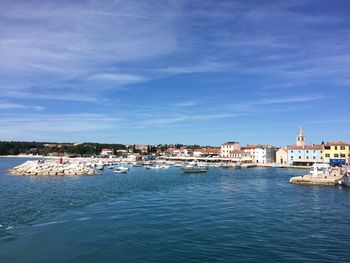 Sailboats in sea against sky