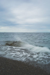 Scenic view of sea against cloudy sky