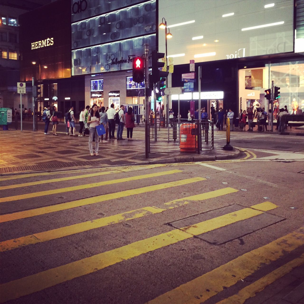 illuminated, night, street, city, large group of people, city life, building exterior, text, men, built structure, road marking, architecture, communication, road, city street, person, lifestyles, western script, transportation