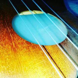 Close-up of guitar on table