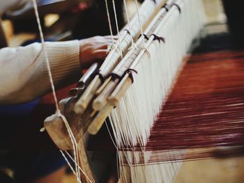 Close-up of person working on handloom