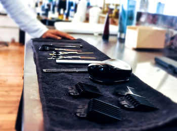 Close-up of tools on towel at barber shop