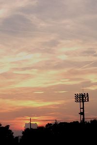 Low angle view of silhouette trees against sky at sunset