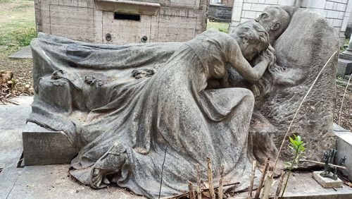 Statue of cemetery against trees