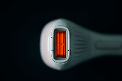 Close-up of thermostat over black background