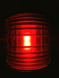 Close-up of illuminated red light in darkroom