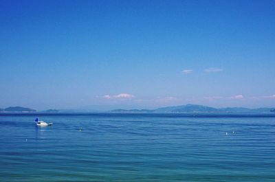 Scenic view of sea against blue sky