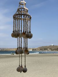 Lifeguard hut on beach against sky
