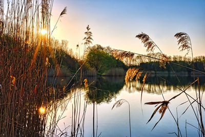 Scenic view of lake against sky at sunset