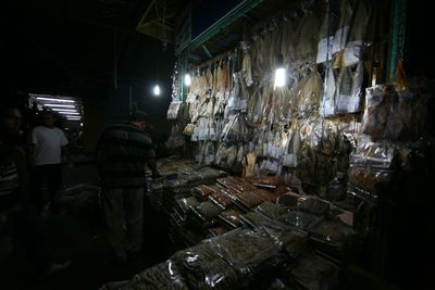 Rear view of people working at night