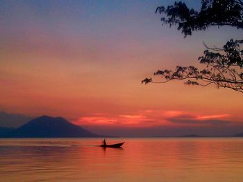 Boat in sea at sunset