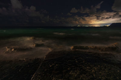 Scenic view of sea against sky at night