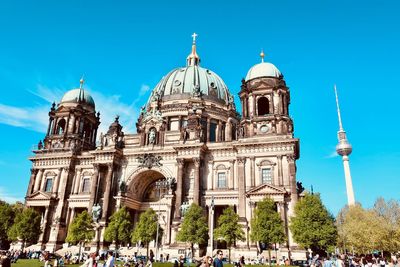 People at berlin cathedral against sky
