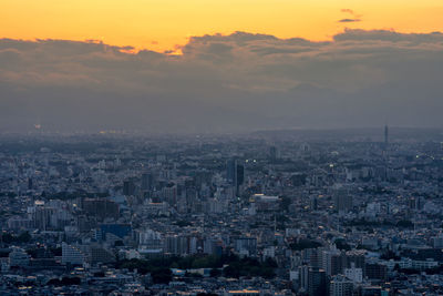 High angle view of city buildings against sky during sunset