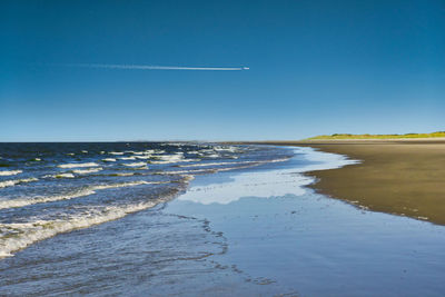 Scenic view of sea against clear blue sky