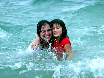 Portrait of happy mother and daughter in sea