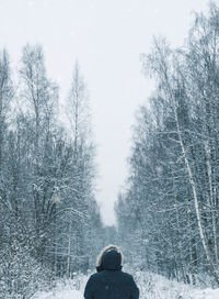 Man on snow covered landscape against sky