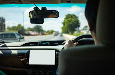 Rear view of man driving car