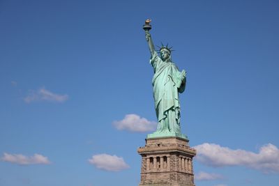 Low angle view of statue of liberty against sky