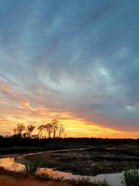 Scenic view of landscape against sky at sunset