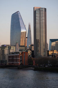 View of buildings at waterfront against sky