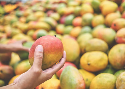 Close-up of hand holding apple at market