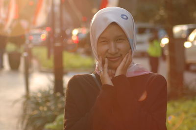 Portrait of smiling young woman wearing hijab