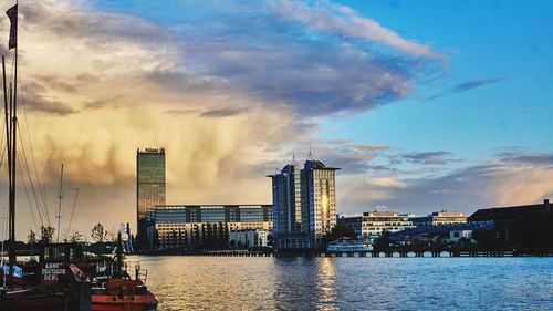 Panoramic view of ship and buildings against sky during sunset