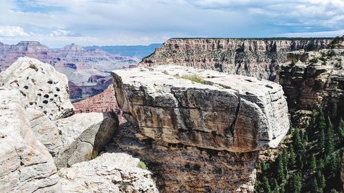 Scenic view of rocky mountains against cloudy sky