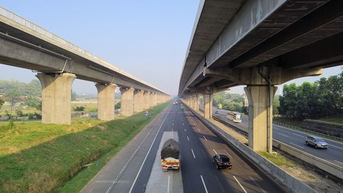 Bridge over highway against sky