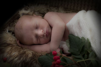 Close-up of baby sleeping in bed