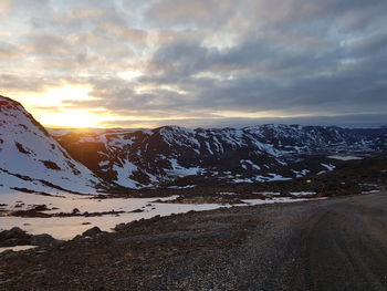 Scenic view of snowcapped mountains against sky during sunset