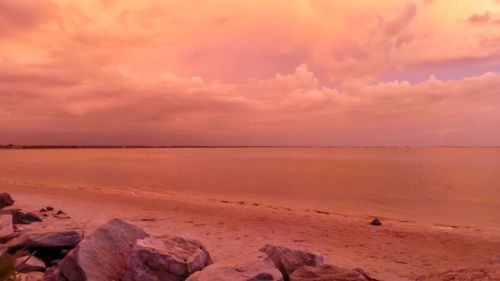 Scenic view of beach against sky during sunset