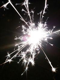 Low angle view of firework display at night