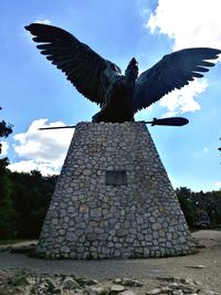 Low angle view of bird flying against sky