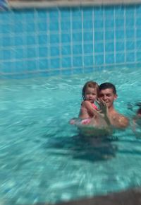 High angle view of young woman swimming in sea