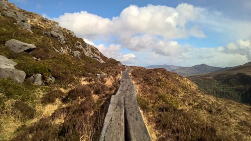 Panoramic view of road amidst mountains against sky