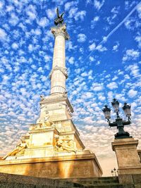 Low angle view of statue against cloudy sky