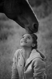 Portrait of smiling girl looking away on field