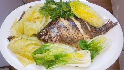 High angle view of fish in plate on table