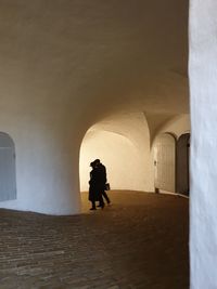 Rear view of silhouette people walking in building