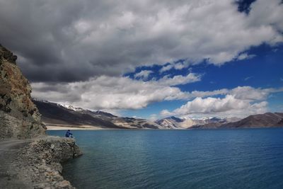 Scenic view of sea and mountains against sky