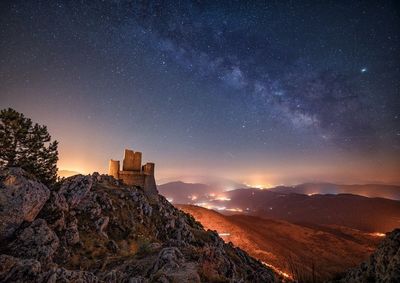 Scenic view of mountains against sky at night, this is most high castle in italy