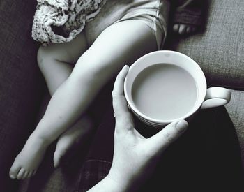 Close-up of hand holding coffee cup