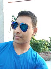 Close-up portrait of young man wearing sunglasses