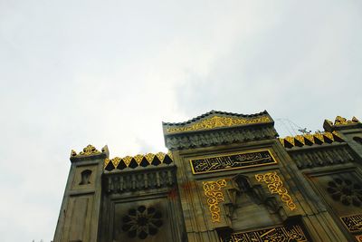 Low angle view of ornate building against sky